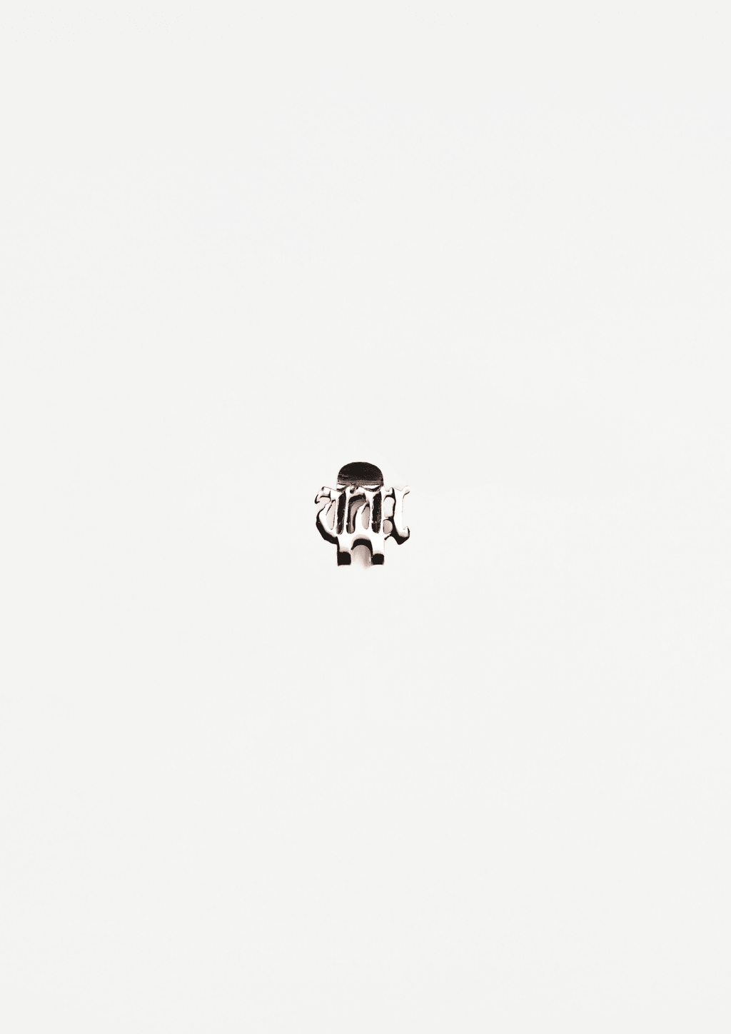Silver-tone cap pin with raised black design