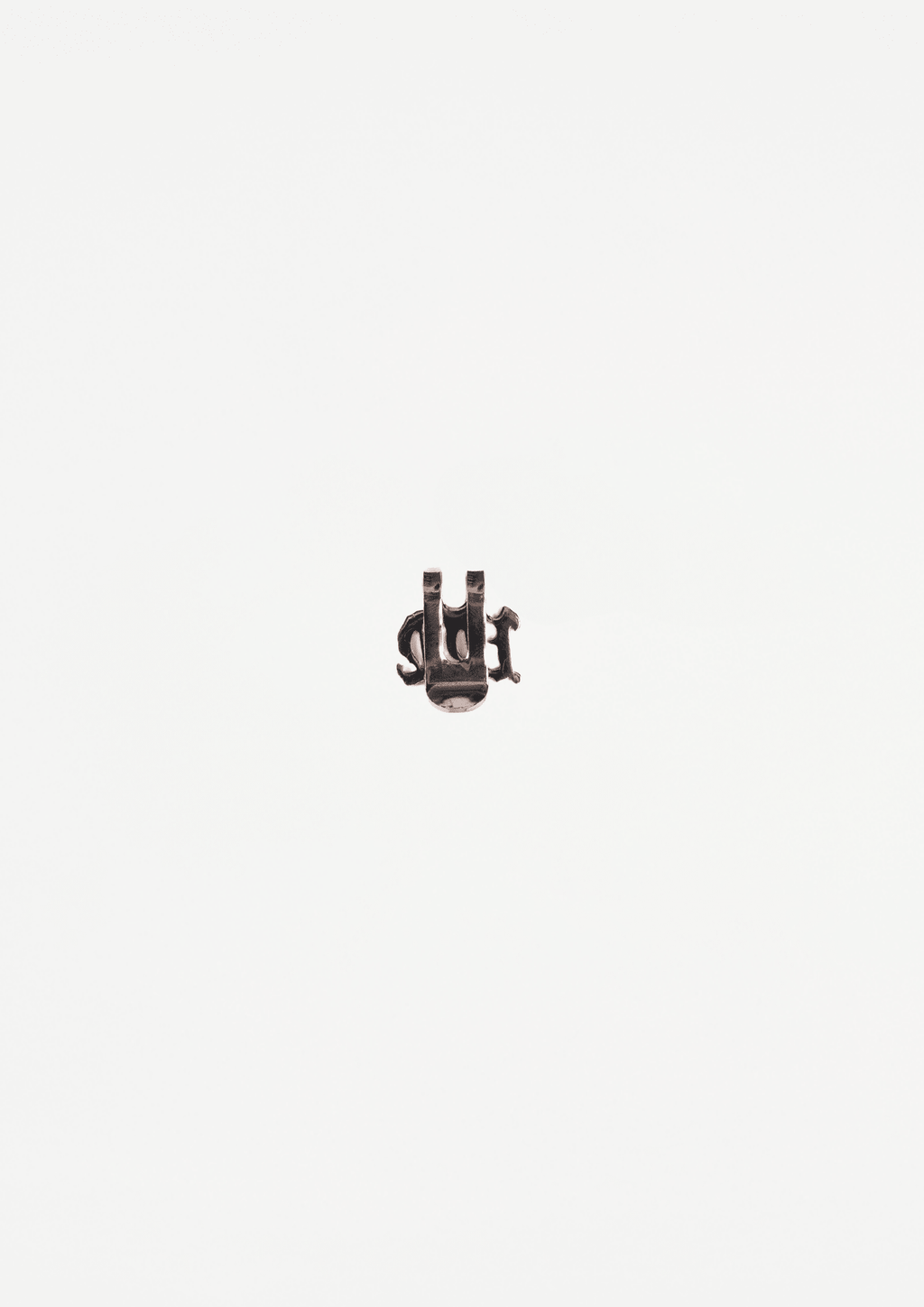 Dark metal cap pin with raised detail