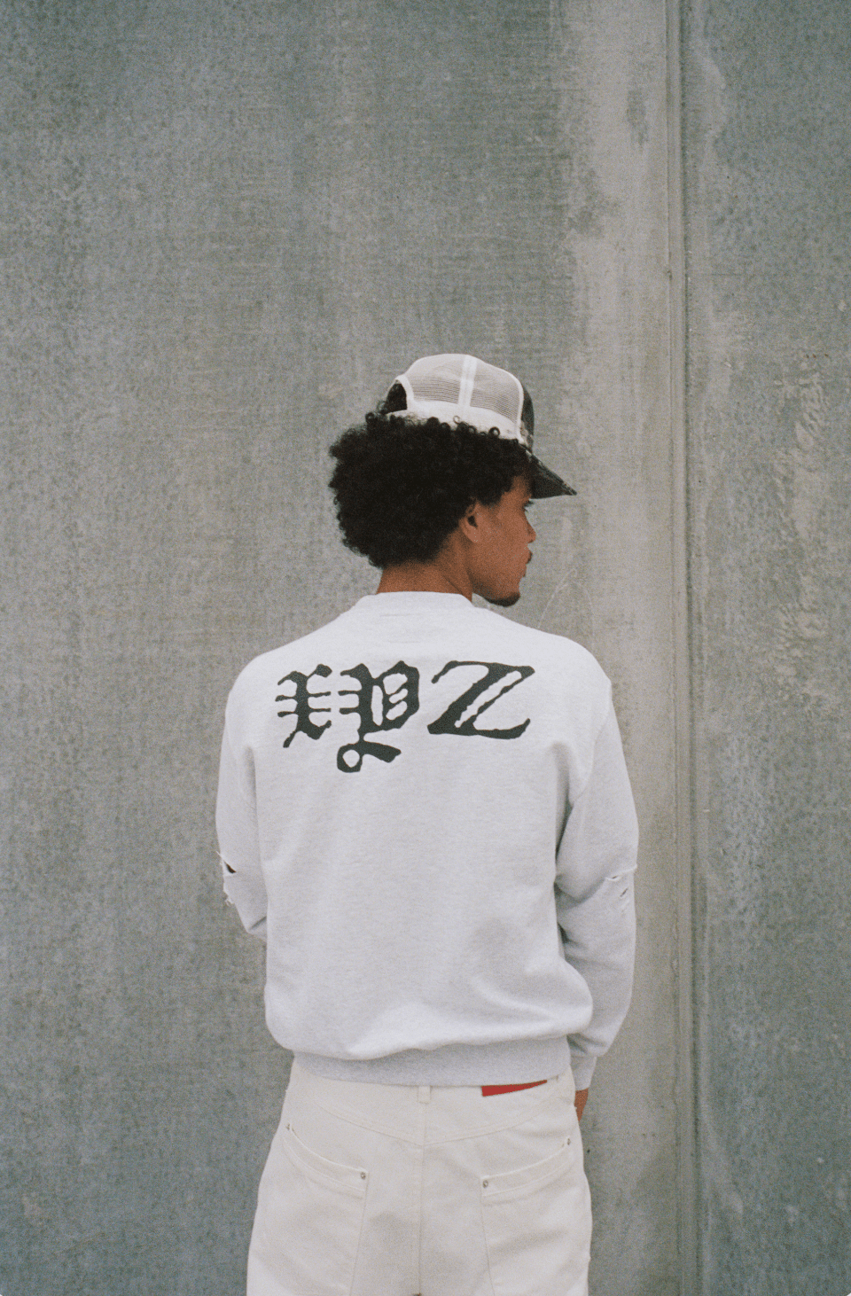 White crewneck sweatshirt with large distressed back text graphic