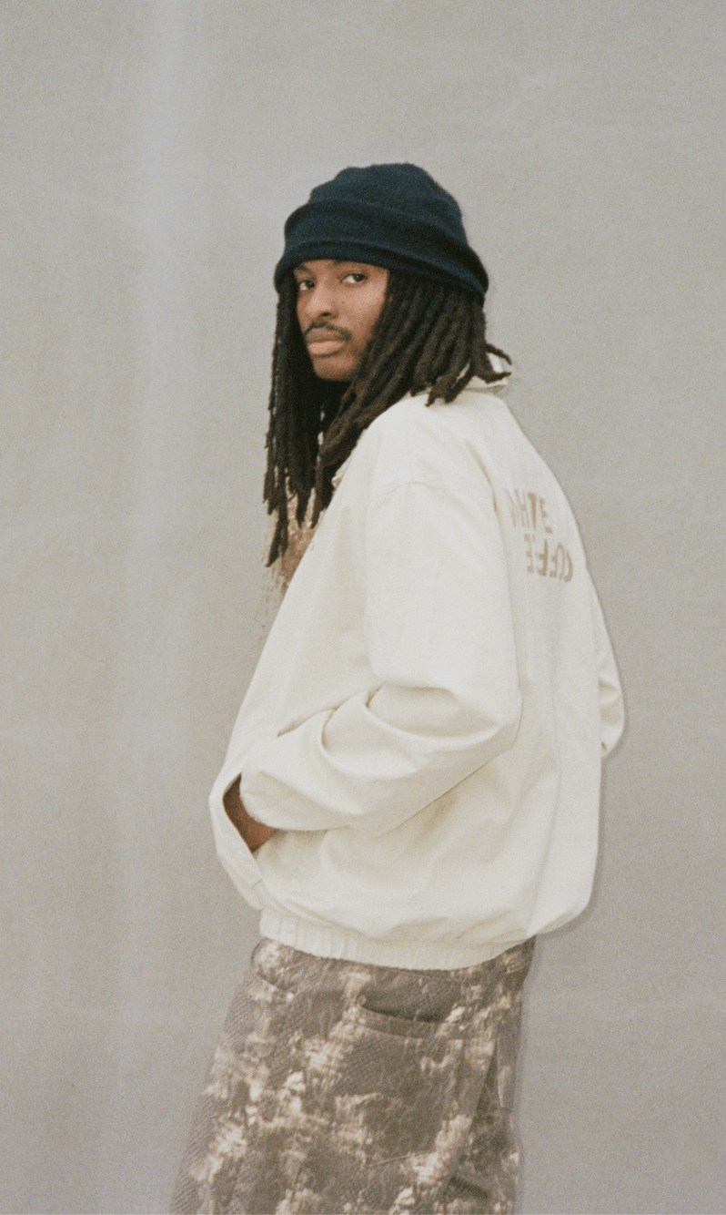 Light funnel-neck jacket on model, full zipper, ribbed hem and cuffs