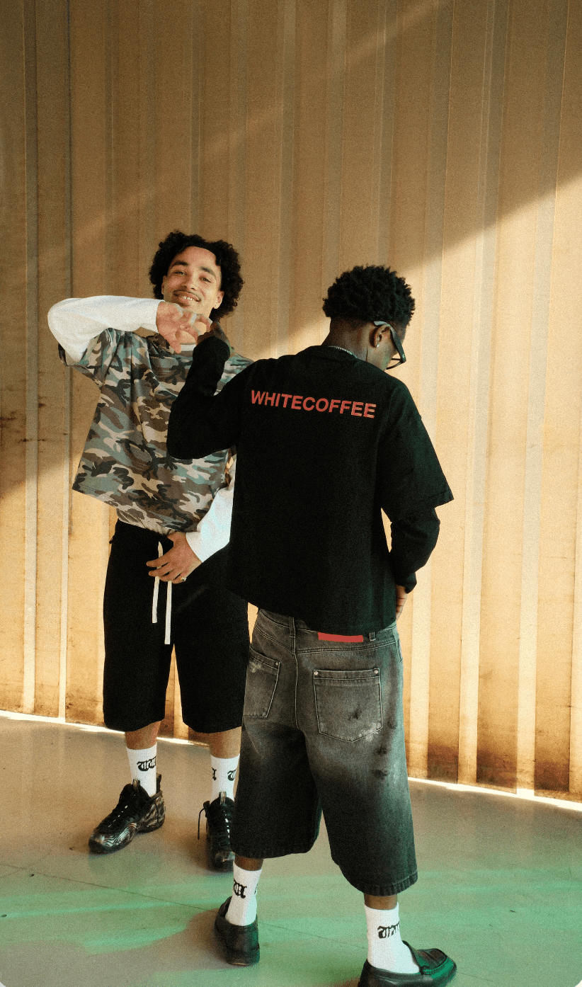 Black hybrid long-sleeve t-shirt worn backward, WHITECOFFEE text on back