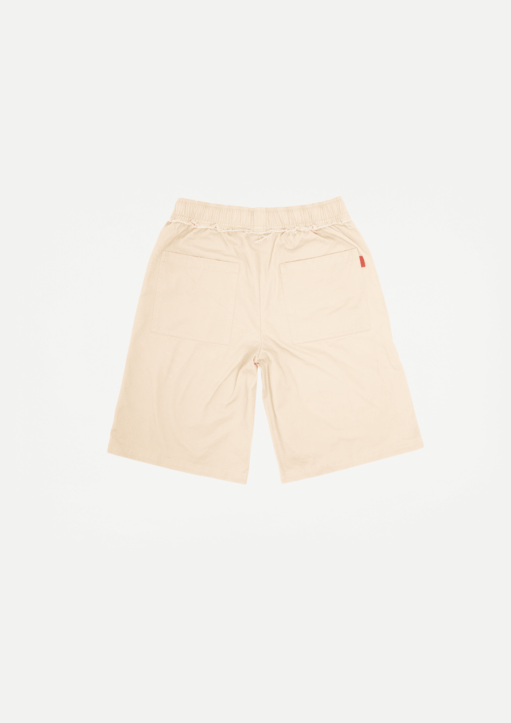 Beige canvas shorts with raw edge hem, elastic waist, and drawstring front