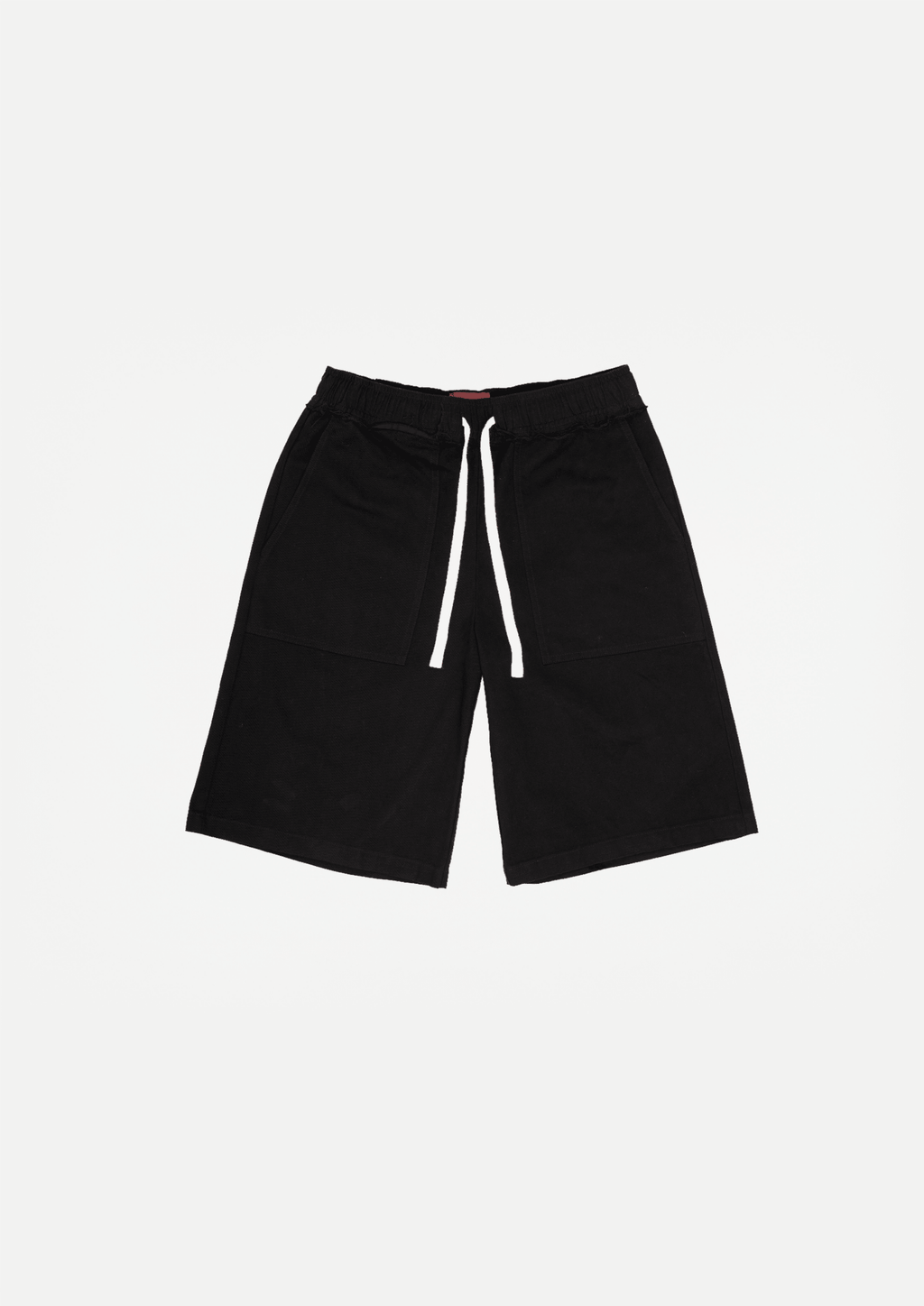 Black canvas shorts with raw hem and white drawstring ties at elastic waistband