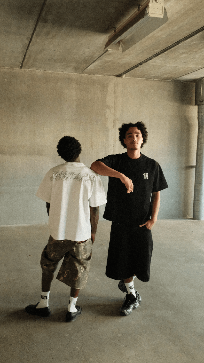 Black crew-neck script t-shirt worn by model, short sleeves